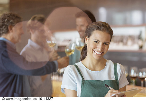 Portrait smiling worker with clipboard in winery tasting room