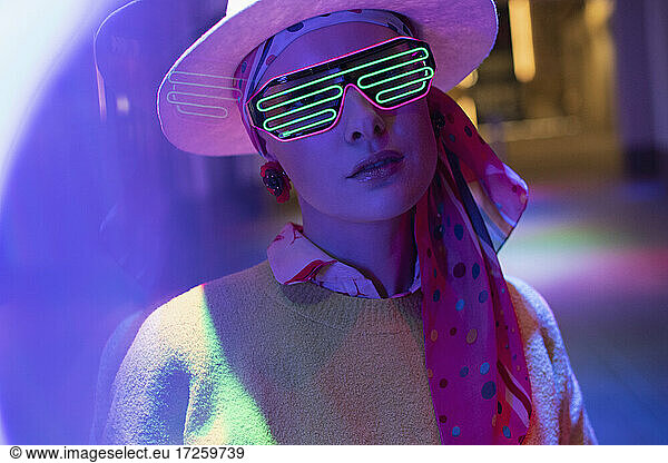 Portrait stylish woman with neon glasses