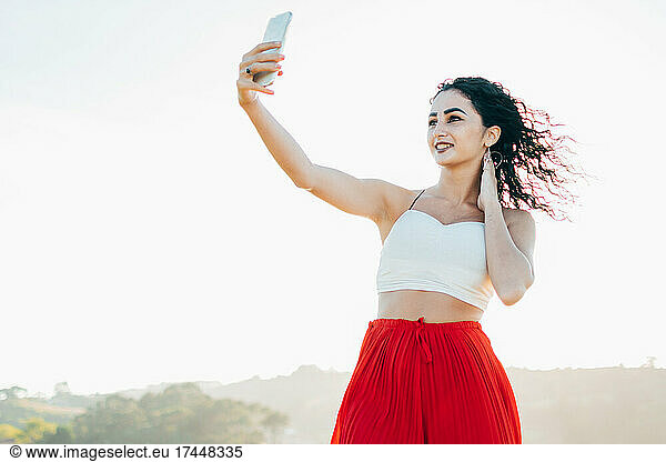 Portrait young woman taking a selfie with mobile phone