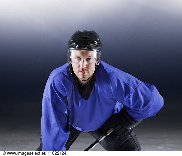 Portraitierter Hockeyspieler in blauer Uniform auf Eis