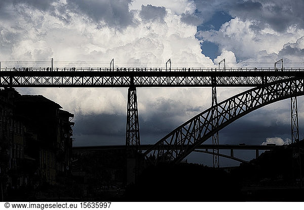 Portugal,  Porto,  Silhouette of Dom Luis I Bridge against large clouds