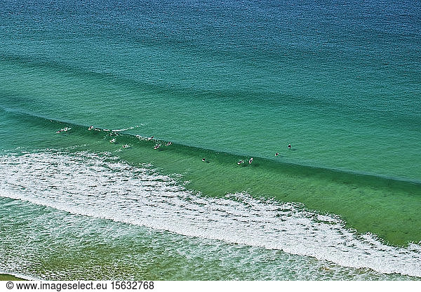 Portugal  Algarve  Arrifana  People surfing in green coastal waters