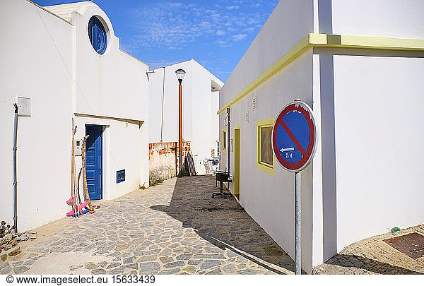 Portugal  Algarve  Arrifana  Road sign in front of empty cobblestone alley between white houses