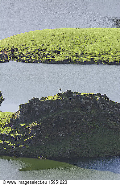Portugal  Azoren  Junge Frau steht auf einem Hügel im Caldeirao-Krater