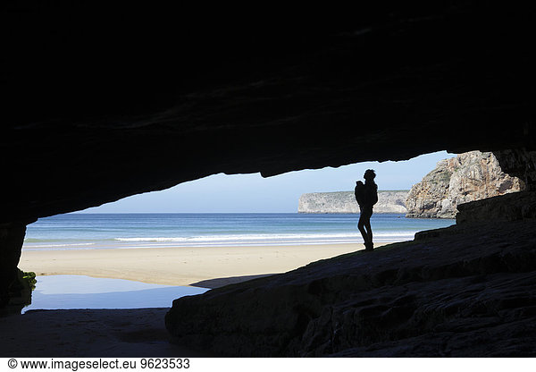 Portugal  Cape St. Vincent  Silhouette of mother and child in cave