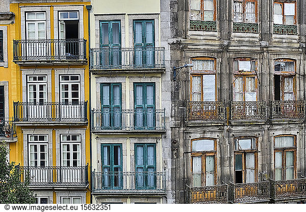 Portugal  Porto  Front view of renovated and neglected building facades