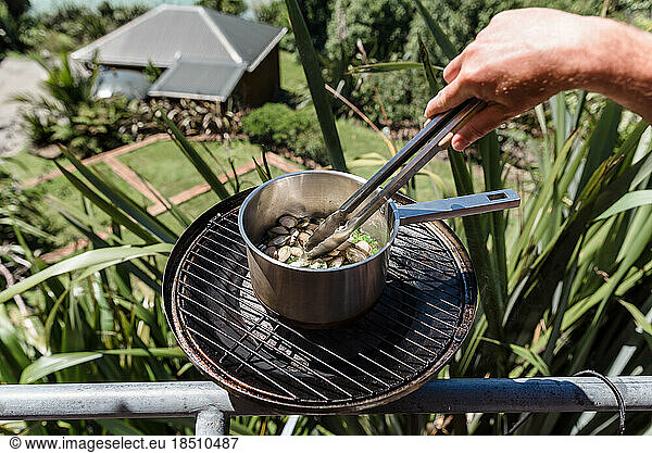 Pot of shellfish being cooked on a balcony grill