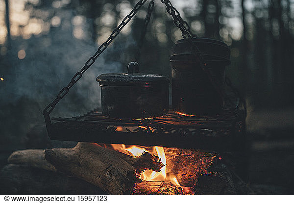 Pots cooking over campfire