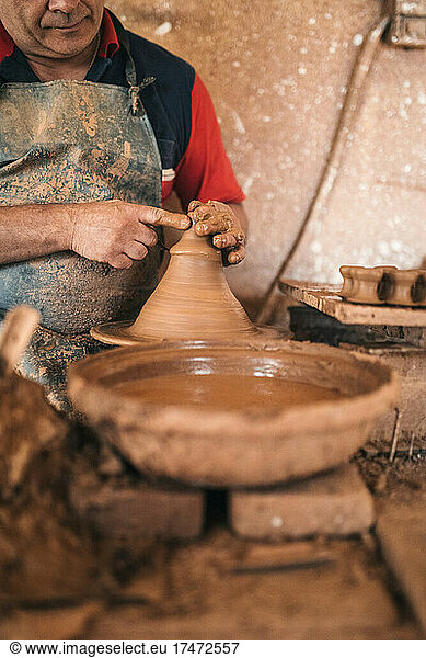 Potter making earthenware in pottery