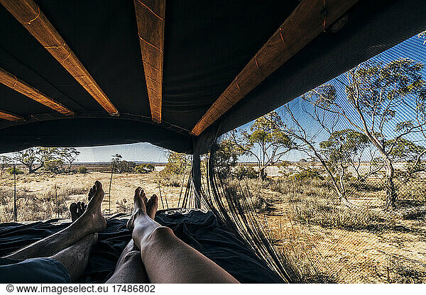 POV carefree couple relaxing in tent in remote landscape  Australia