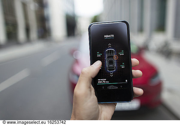 POV Man using remote car access app on smart phone