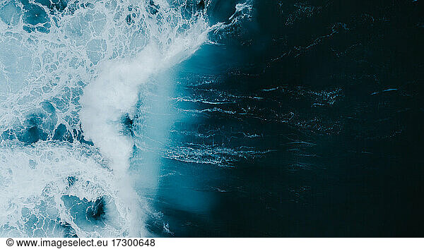 Powerful wave breaking in an overhead view from a drone