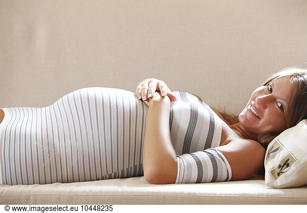 pregnant woman laying down on couch