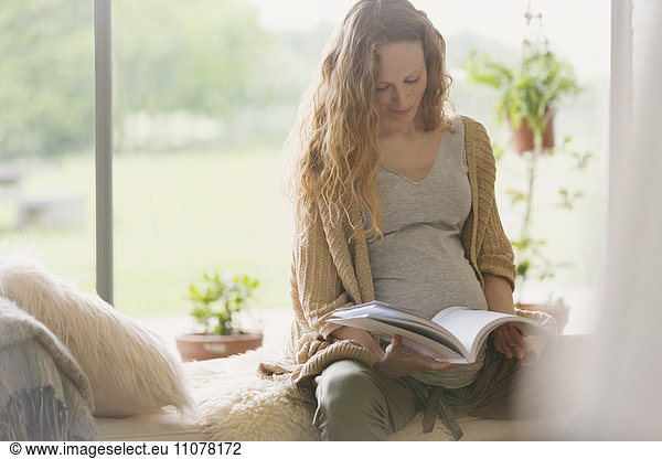Pregnant woman reading book
