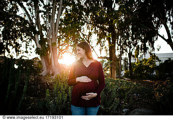 Pregnant Woman Standing in Garden During Sunset in San Diego