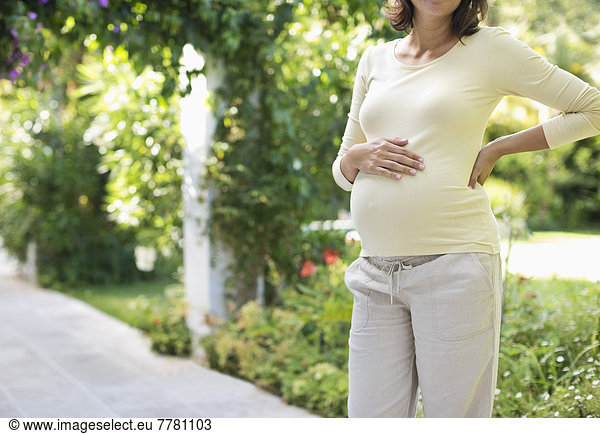 Pregnant woman standing outdoors