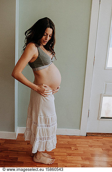 Pregnant woman white skirt and bra