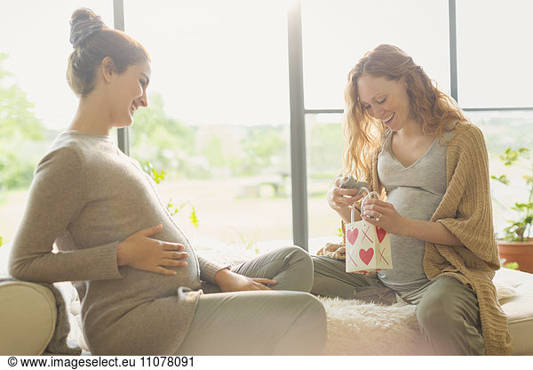 Pregnant women opening gifts