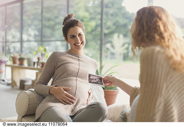 Pregnant women sharing ultrasound