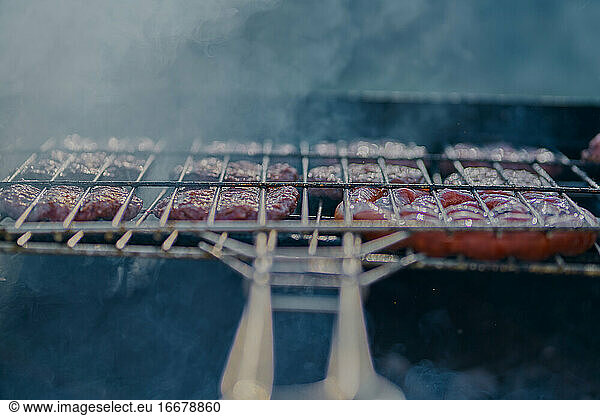 preparation of barbecue on bacon and sausage grill