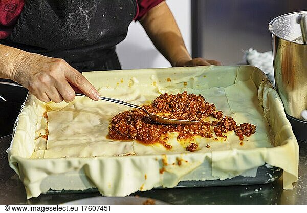 Preparing a lasagne in the kitchen of an agriturismo  Maremma  Province of Livorno  Tuscany  Italy  Europe