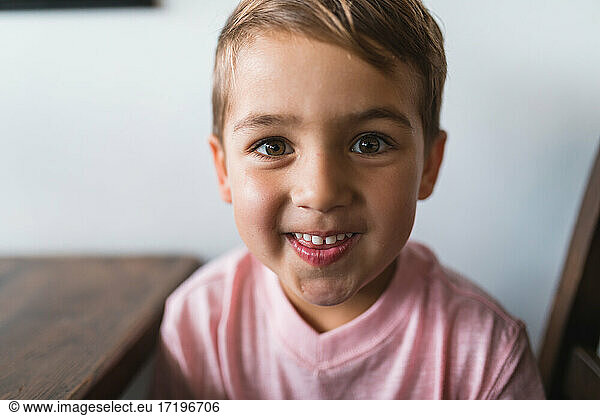 Preschooler aged boy smiling at the camera