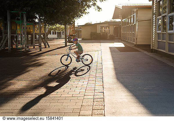 Preschooler riding a bicycle at dusk