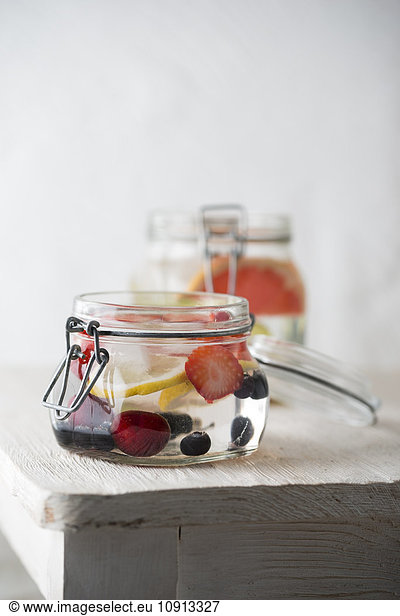 Preserving jar of cooled water flavoured with different fruits