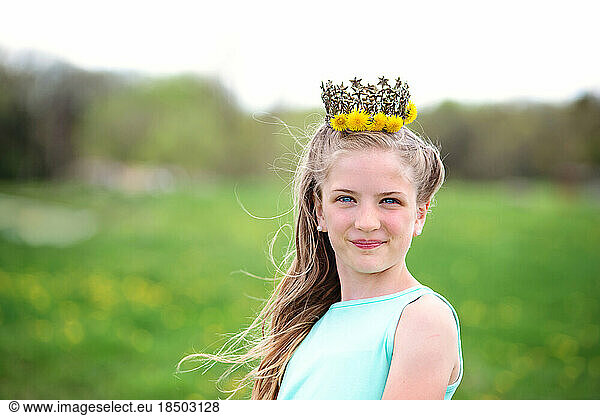 Pretty blond tween girl with dandelion crown.