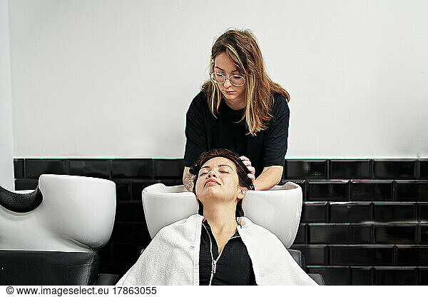 pretty Female hairdresser while working.
