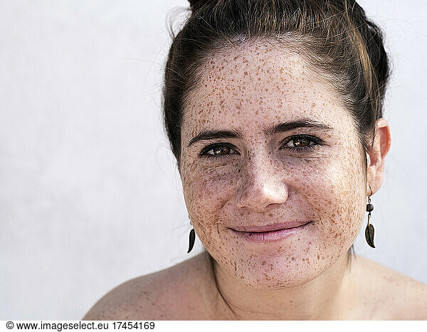 Pretty girl with freckles smiling