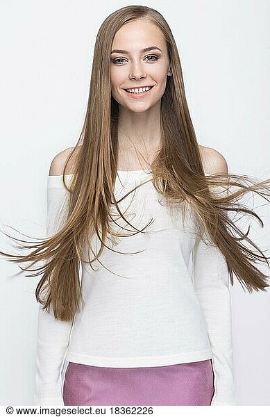 Pretty girl with smile in fashionable stylish clothes  on a white background. Picture taken in the studio. Beauty  fashion  style