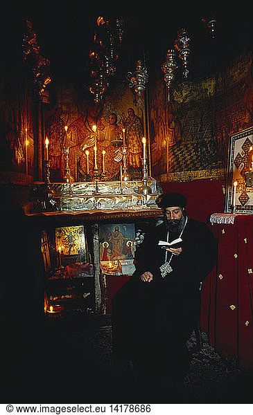 Priest Reading Inside Coptic Chapel  Jerusalem