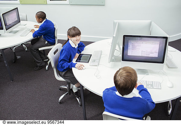 Primary school children working with computers