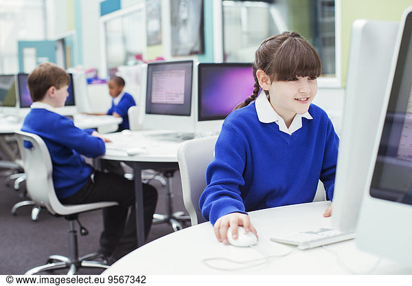 Primary school children working with computers during IT lesson