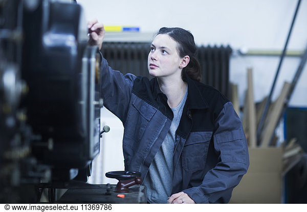 Print worker adjusting printing machine in an industry