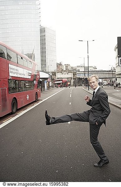 Proactive businessman crossing street in London  UK.