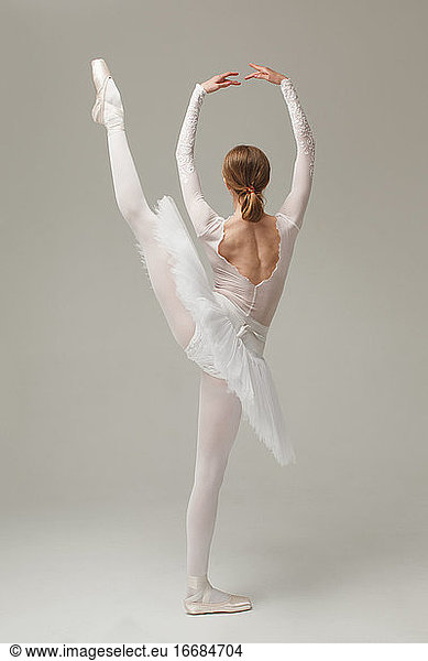 professional ballet dancer doing ballet move developpe  studio shot