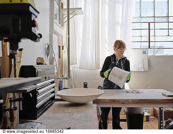Professional female sculptor working in her studio