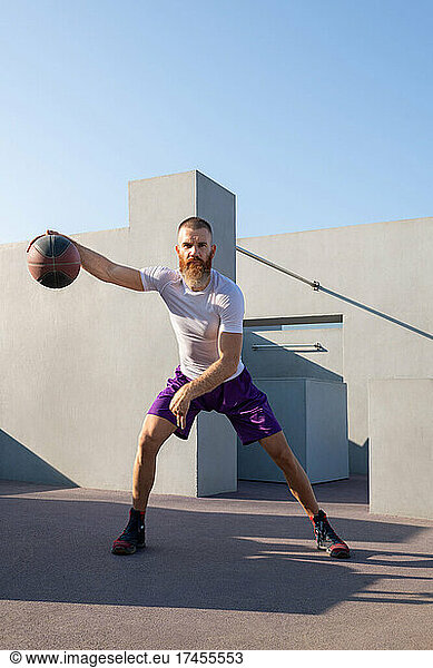 Professional sportsman playing basketball outdoors