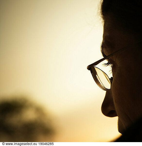 Profile of a woman wearing glasses.