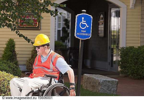 Project engineer in wheelchair with Spinal Cord Injury at accessible parking site