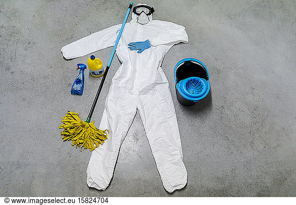 Protective clothes  cleaning agents  bucket and sanitizer lying on floor
