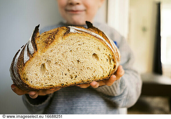 Proud Preschooler showing off his homemade sourdough bread.