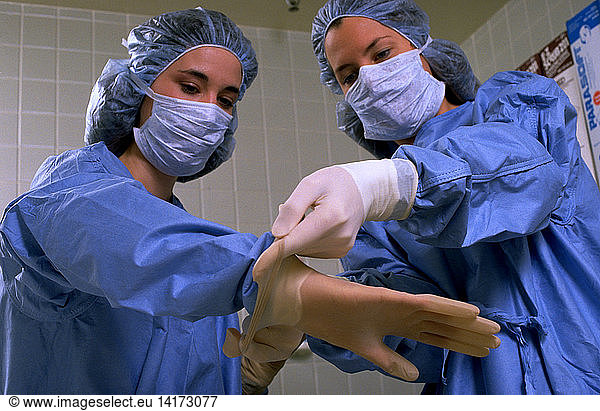 Putting on surgical gloves