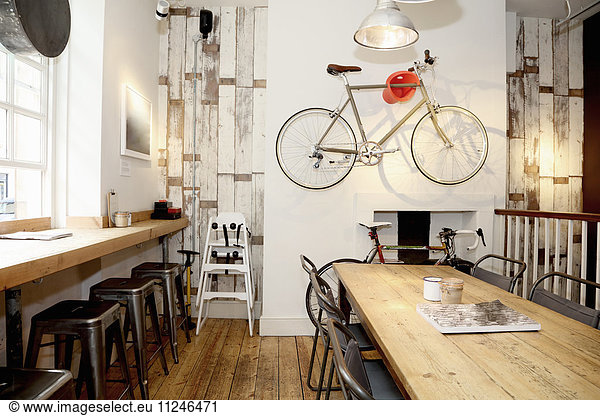 Quirky coffee shop interior with bicycle on wall