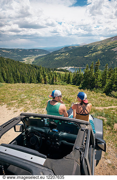 Rückansicht eines Roadtrip-Paares auf einem Vierrad-Cabriolet in den Rocky Mountains  Breckenridge  Colorado  USA
