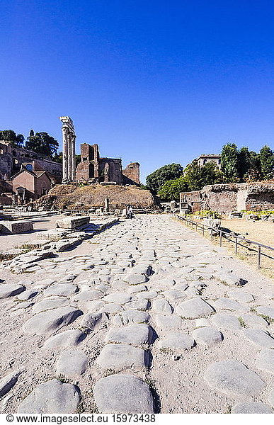 Römerstraße Kastor- und Pollux-Tempel dahinter der Palatinhügel Römisches Forum UNESCO-Weltkulturerbe Rom Latium Italien Europa