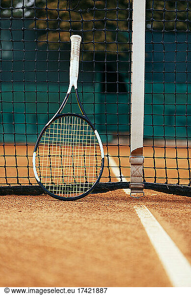 Racket on tennis court net