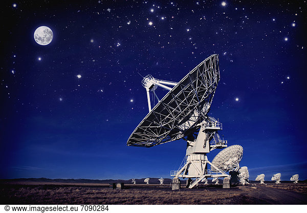 Radio telescopes in the landscape in New Mexico. Night. Antennae in rows.